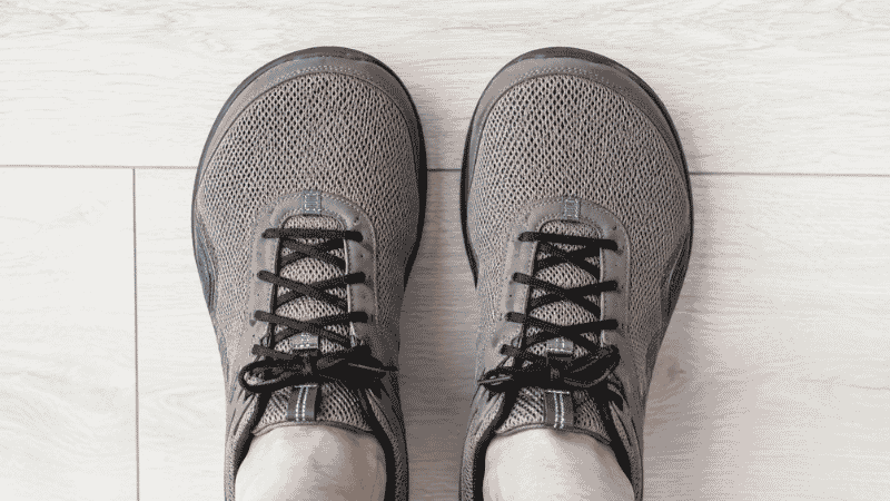Top-down view of a pair of feet inside wide toe box walking shoes showing natural toe spread with no compression on the sides