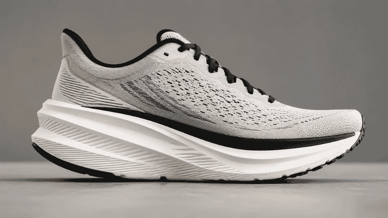 Close-up of a carbon plate running shoe with distinctive thick midsole and aggressive rocker geometry, representing the super shoe technology used in elite marathon racing