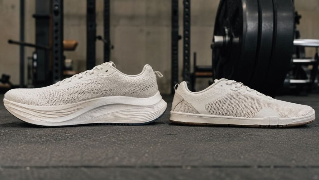 Side by side comparison of a cushioned running shoe and a flat training shoe placed next to gym equipment, representing the difference between shoes designed for running versus weightlifting and gym training